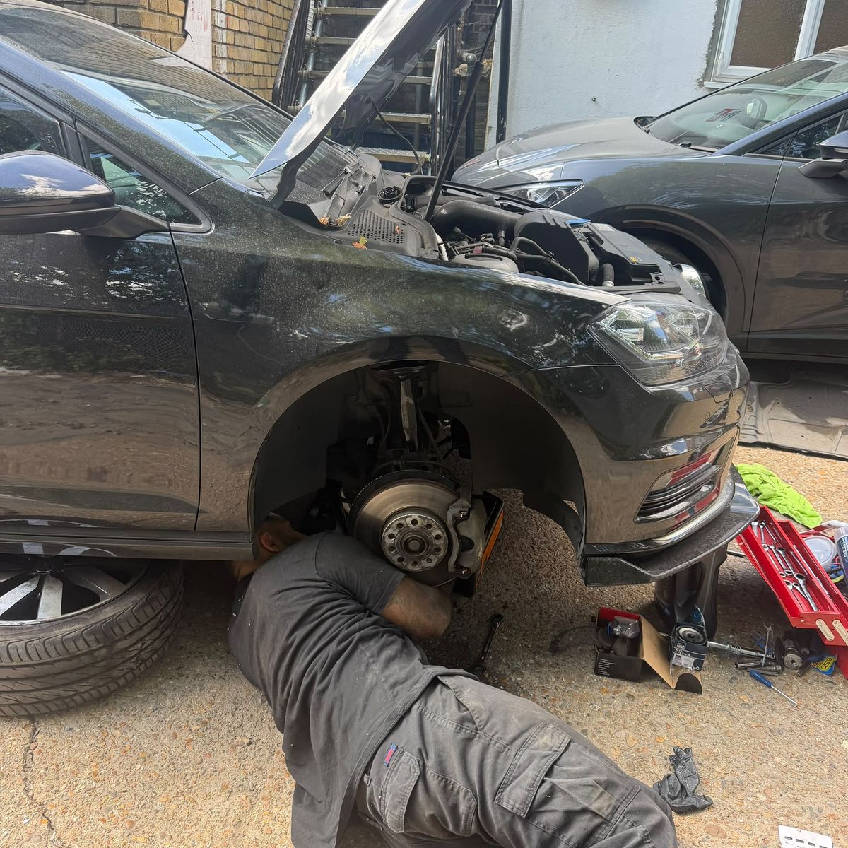 Front brake disc and hub exposed on a Volkswagen Golf during a brake replacement