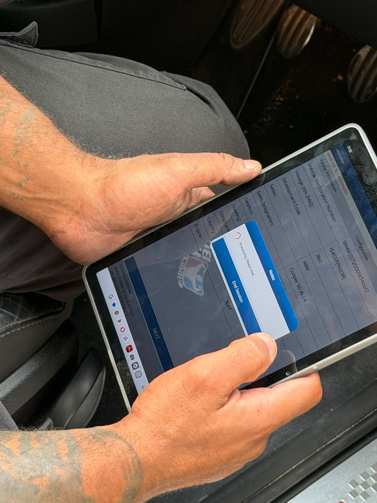 Technician reading live vehicle data on a diagnostic tablet